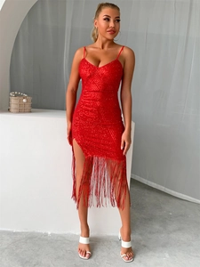 Detail of red sequined dress featuring tassel hem and high side slit for party wear