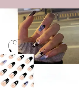 Detail of French star press-on nails with black and blue glitter rhinestone accents