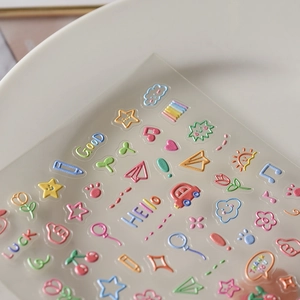 Macro shot of 3D colorful cartoon nail stickers with clouds, stars and heart patterns
