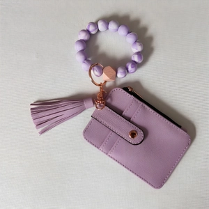 Detail of purple PU leather card holder with silicone bead wristlet and rose gold hardware