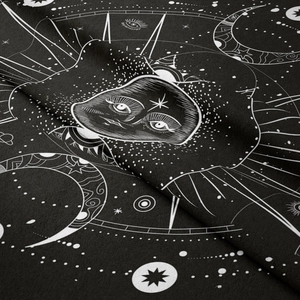 Macro detail of sun and moon bohemian tapestry featuring occult stars and celestial patterns