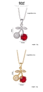 Detail view of red cherry pendant necklaces with dimensions 16x14.3mm and 40+5cm chain length