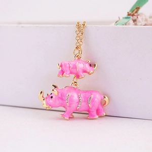 Charming golden rhinoceros keychain with pink enamel, sparkling rhinestones and floral accents