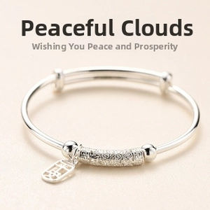 Close-up of vintage silver bracelet with engraved clouds and Pingan pendant tag