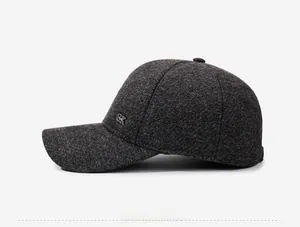 Dettaglio ravvicinato del cappellino grigio scuro testurizzato con logo GX in metallo