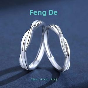 Macro detail of S925 sterling silver Mobius couple rings with sparkling zircon inlay