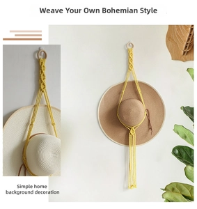 Detail of yellow macrame hat organizer showing handwoven texture and wooden ring hanger