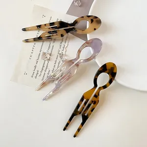 Elegant U-shaped acetate hair pins in tortoiseshell and lavender for French bun styling