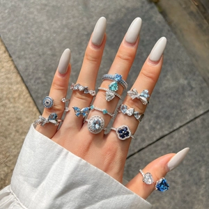Detail view of S925 silver ring set with blue heart zircon and butterfly motifs on hand