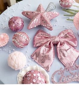 Pink Christmas ornaments detail with sequined bows, star topper and festive foam balls