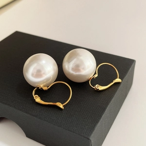 14K gold plated hoop earrings with large round white pearls on a black display box
