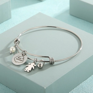 Détail du bracelet en acier inoxydable argenté avec perle et pendentif Joyeux Noël