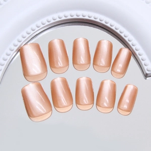 Handmade amber cat-eye press-on nails in nude pink with a square round shape