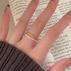 Minimalist 925 sterling silver twisted rings in gold and silver finish on hand