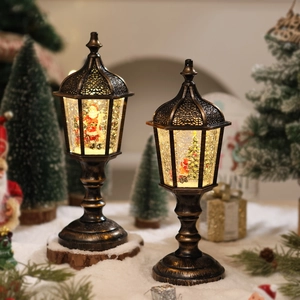 Detail of vintage Christmas lanterns with Santa Claus and LED glowing glitter snow effect