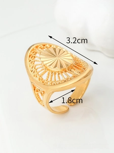 Detailed macro view of 3.2cm golden hollow filigree ring with adjustable open band
