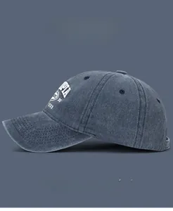 Detailed view of vintage washed denim baseball cap with 3D embroidery and metal eyelets