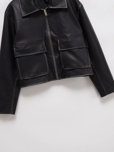 Detail of black PU leather jacket with zipper closure and two large flap pockets