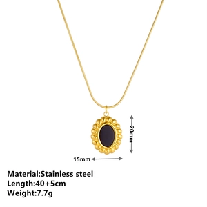 Golden stainless steel snake chain necklace with black oval stone pendant on white background