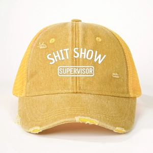 Close-up of distressed yellow denim trucker hat with SHIT SHOW SUPERVISOR print