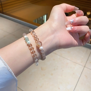 Macro shot of double-layered beaded bracelet with chalcedony, crystal, and pearls on wrist
