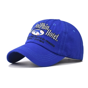 Detailed embroidery of white Dolphin Hotel logo on washed cotton baseball cap