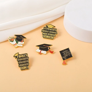 Finally Graduated enamel pin set with graduation cap and diploma on pink background