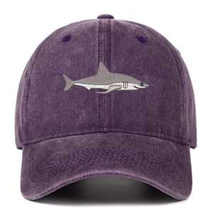 Close-up of premium shark embroidery on washed dark purple cotton baseball cap fabric