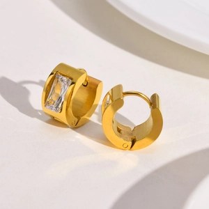 Detailed macro view of 18K gold polished hoop earrings with clear baguette zircon stones