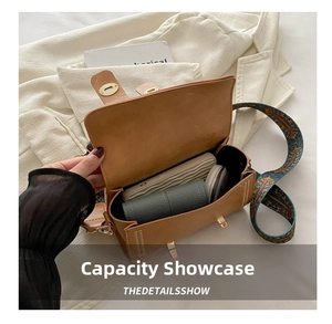 Interior view of brown leather saddle bag showing storage capacity with woven strap