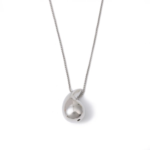 Macro detail of silver teardrop pendant with high-polish finish on a fine box chain