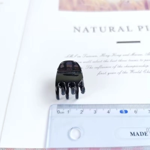 Close-up of 2cm mini square hair claw clip in black finish with measuring ruler