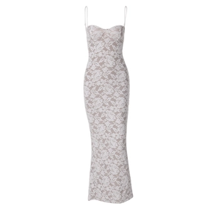 Detail of white lace pattern with thin spaghetti straps on a slim fit maxi dress