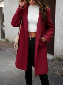 Detail of red wool coat sleeves with triple buttons and a classic lapel design