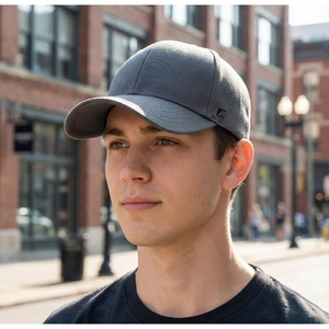 Close-up of a dark grey cotton baseball cap showing 6-panel structure and side tag