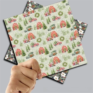 Detail showing vintage Christmas scrapbook paper with red barn and festive truck patterns