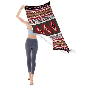 Microfiber beach towel featuring Aztec geometric patterns in ethnic style shown by model