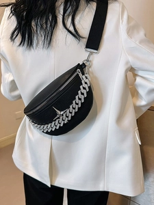 Fashionable black pebble leather crossbody bag with bold silver chain and star logo