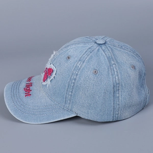 Detail of red Free flight embroidery on brim of light blue distressed denim baseball cap