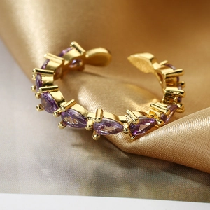 Elegant gold-plated adjustable ring featuring marquise-cut purple zircons on satin
