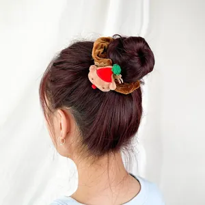 Detail of plush brown reindeer scrunchie used in hair bun for Christmas decoration