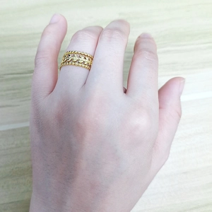 Close-up of 18K gold-plated adjustable ring with intricate hollow leaf design details