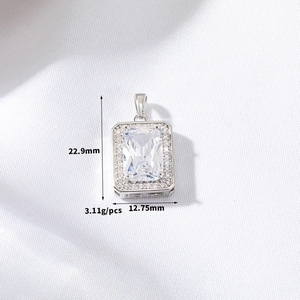 Macro shot of a rectangular purple zircon pendant with size specs and dimensions