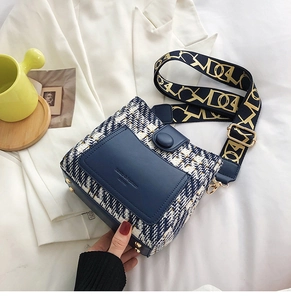 Detail of tweed crossbody bag with blue leather pocket and jacquard wide shoulder strap