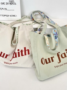 Floral lined canvas tote bag in cream and green with Our Faith print and music slogan