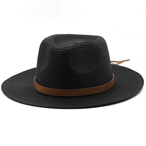 Close-up of black wide brim straw hat with brown textured faux leather decorative band