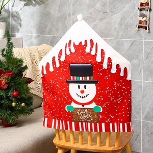Close-up of a festive red snowman chair cover with Warm Wishes sign and striped trim