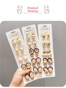 Close-up of children's elastic hair bands featuring cute resin bear and flower charms