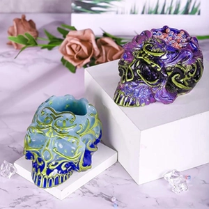 Detailed relief patterns on colorful skull-shaped resin candle holders and diy molds