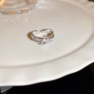 Macro shot of double-layer open ring featuring a zircon-studded D-letter detail